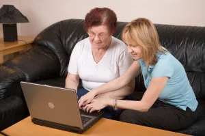 Our employee provides technology assistance to a Moon River client