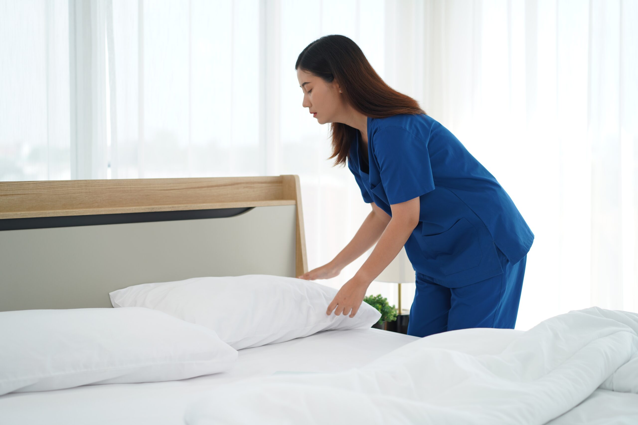 Young,Caregiver,Female,In,Uniform,Was,Cleaning,And,Bedding,Arranged